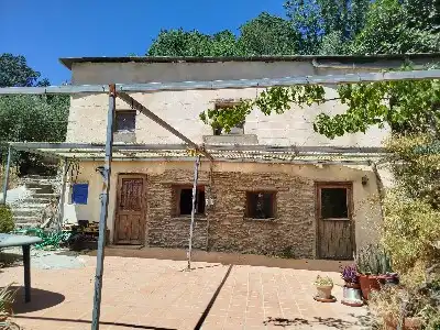 Vista exterior de Finca rústica en venda en Alpujarra de la Sierra amb Calefacció, Jardí privat i Moblat