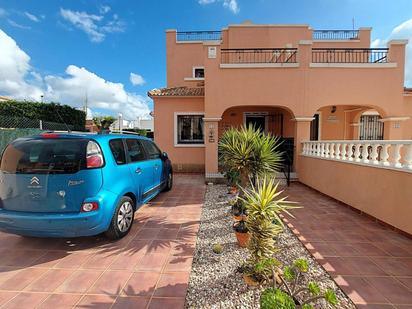 Exterior view of Single-family semi-detached for sale in Los Montesinos  with Air Conditioner, Swimming Pool and Community pool