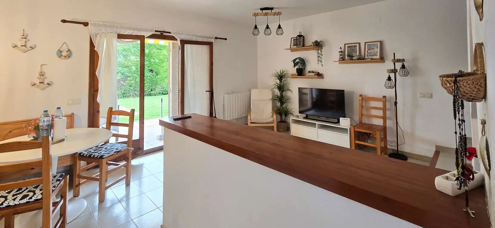 Sala d'estar de Casa adosada en venda en L'Escala amb Aire condicionat, Terrassa i Moblat