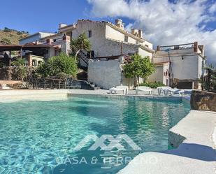 Swimming pool of Building for sale in Canillas de Aceituno