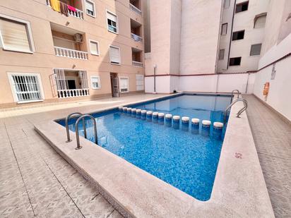 Swimming pool of Flat for sale in Torrevieja  with Air Conditioner, Heating and Terrace