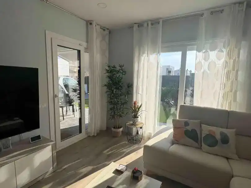 Living room of Flat for sale in Cunit  with Air Conditioner, Private garden and Parquet flooring