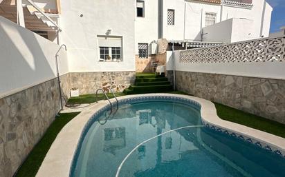 Swimming pool of Single-family semi-detached for sale in Roquetas de Mar