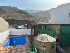 Vista exterior de Casa adosada en venda en Mogán amb Jardí privat, Piscina i Moblat