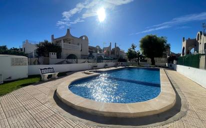Swimming pool of Single-family semi-detached for sale in Torrevieja  with Air Conditioner, Heating and Terrace