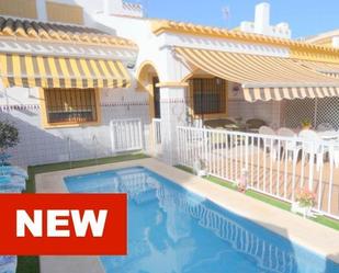 Exterior view of Single-family semi-detached for sale in Pilar de la Horadada  with Air Conditioner and Swimming Pool