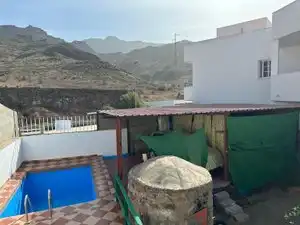 Vista exterior de Casa adosada en venda en Mogán amb Jardí privat, Piscina i Moblat
