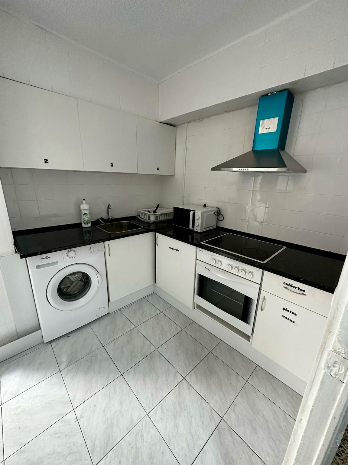 Kitchen of Flat to share in  Valencia Capital  with Washing machine and TV