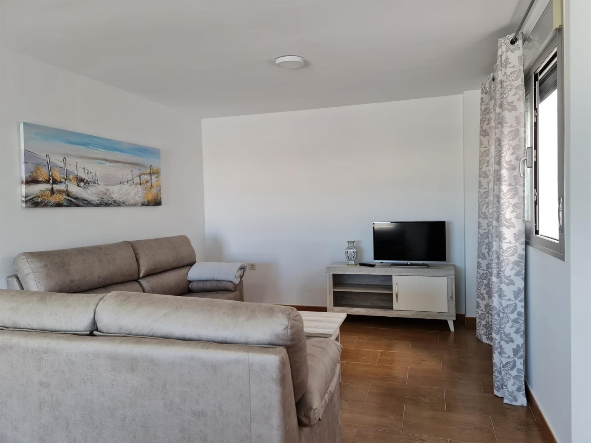 Sala d'estar de Pis de lloguer en Conil de la Frontera amb Aire condicionat, Terrassa i Moblat