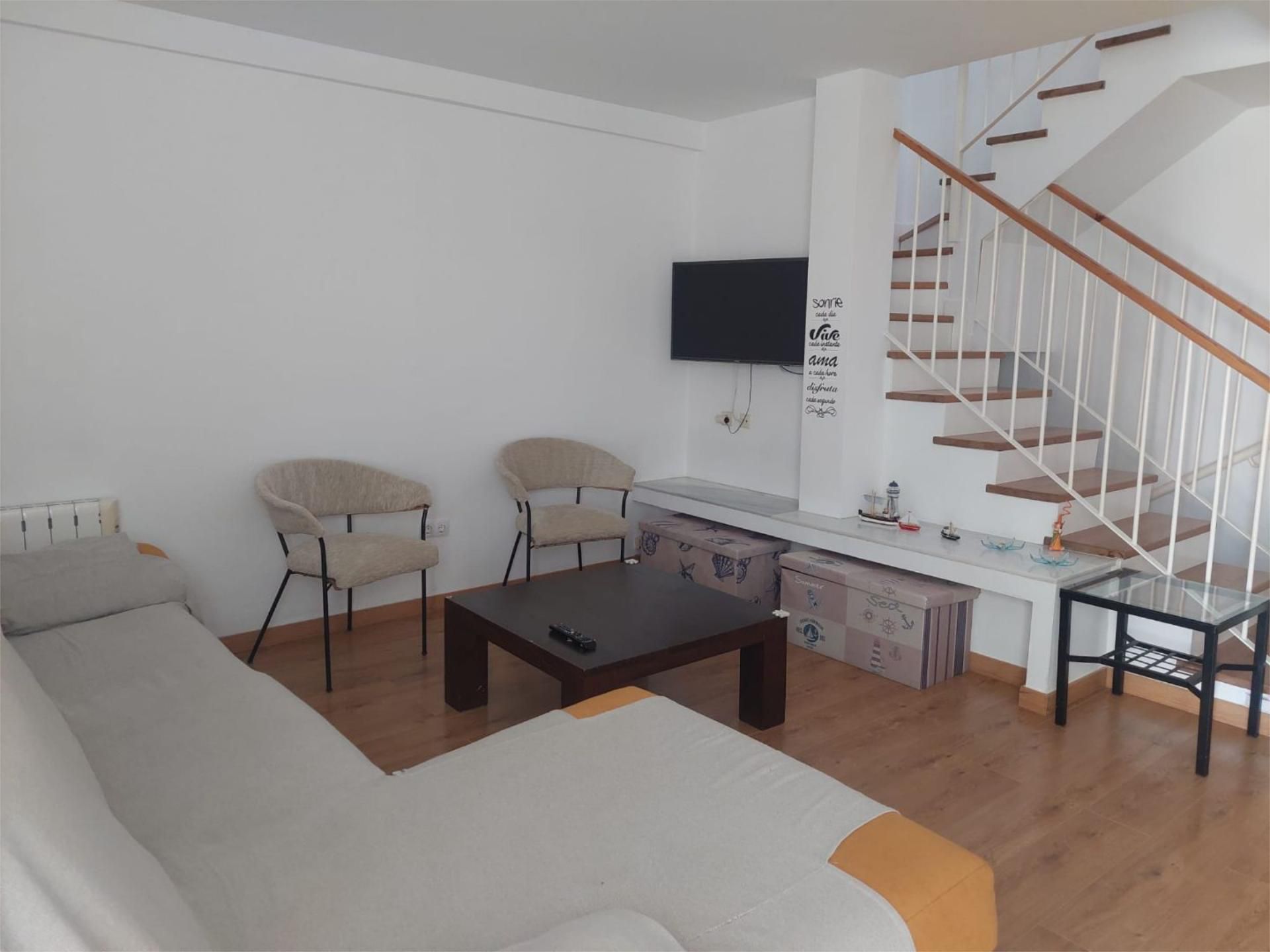 Sala d'estar de Casa adosada de lloguer en El Rompido amb Aire condicionat, Terrassa i Piscina