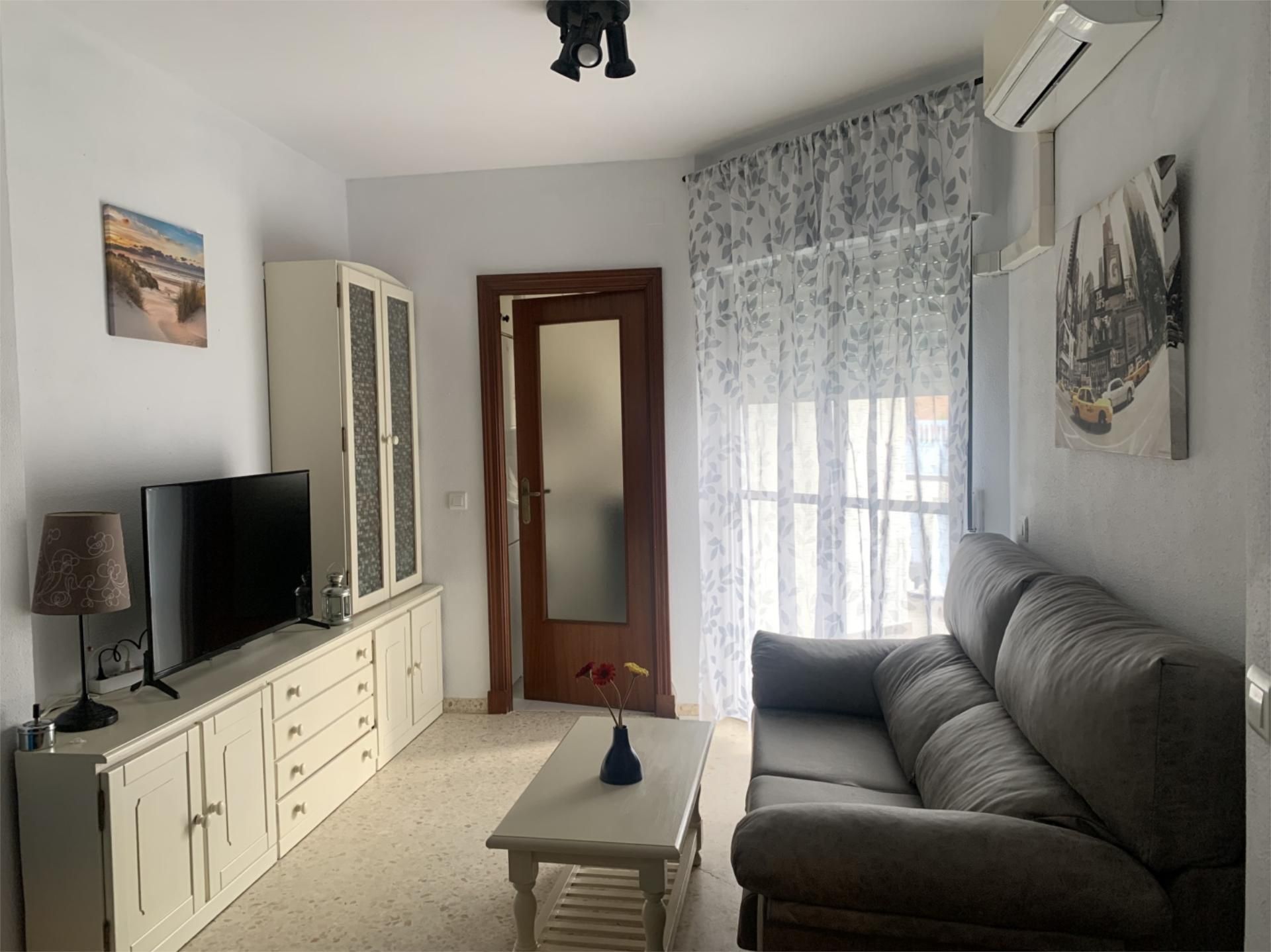 Sala d'estar de Pis de lloguer en El Portil amb Aire condicionat, Terrassa i Moblat